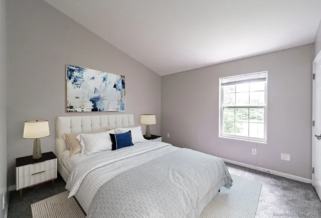 a bedroom with a bed and lamp