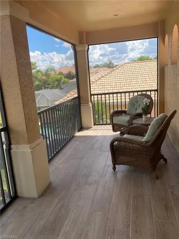 a balcony with furniture and a potted plant
