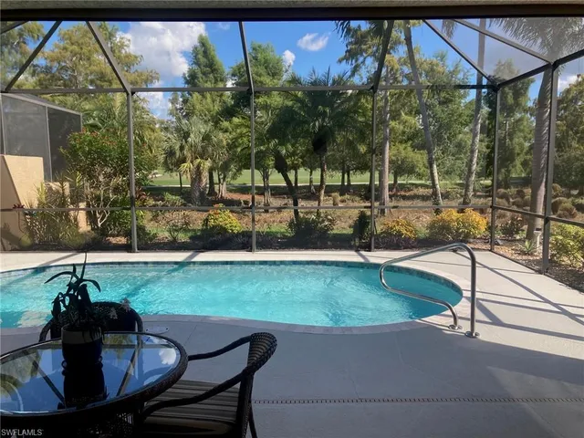 a backyard of a house with table and chairs