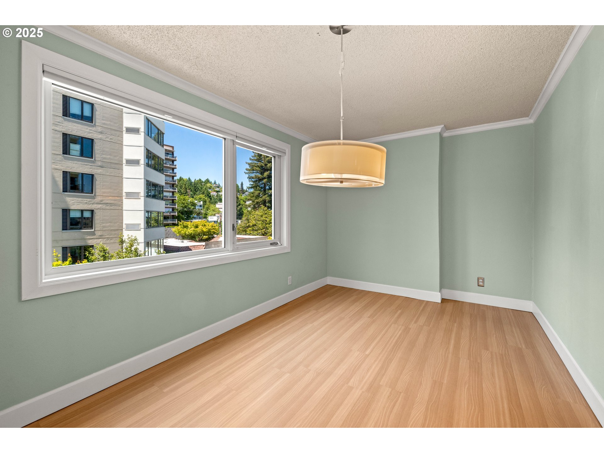 2211 Southwest Park Place, Unit 603 Portland, OR 97205 - Photo 12 of 27 a view of an empty room with window and wooden floor