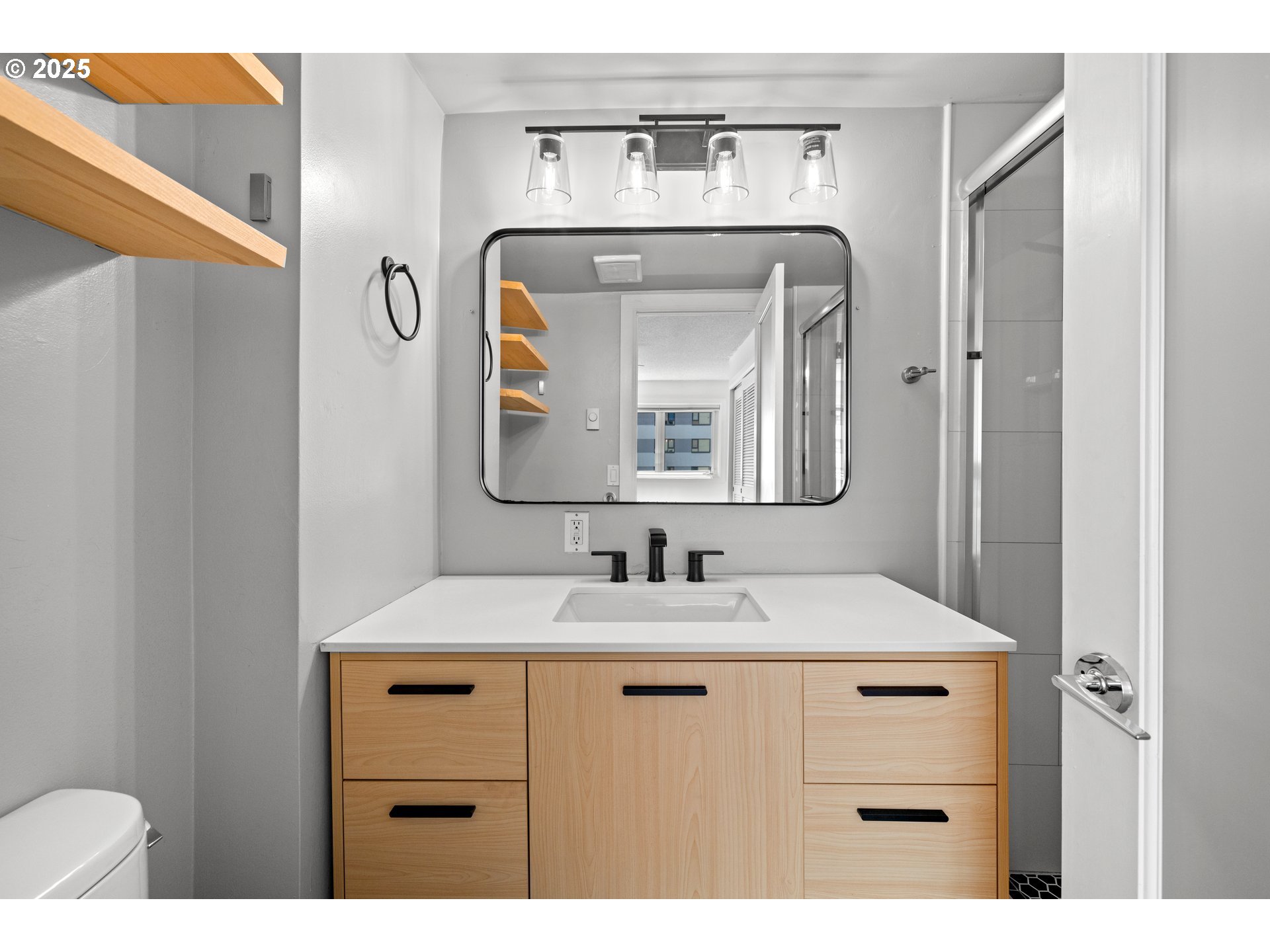 2211 Southwest Park Place, Unit 603 Portland, OR 97205 - Photo 20 of 27 a bathroom with a sink vanity and a mirror