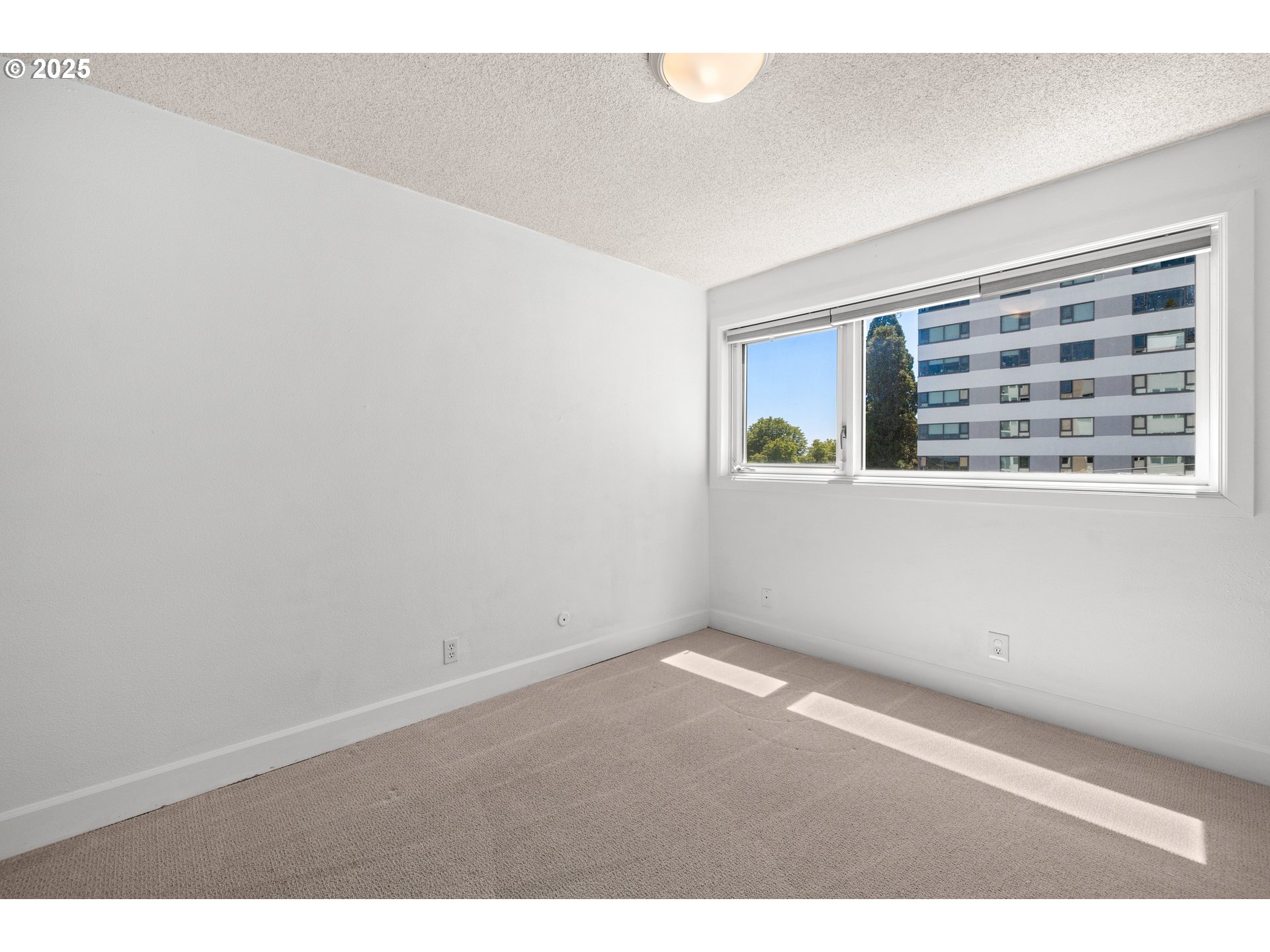 2211 Southwest Park Place, Unit 603 Portland, OR 97205 - Photo 23 of 27 a view of an empty room with a window
