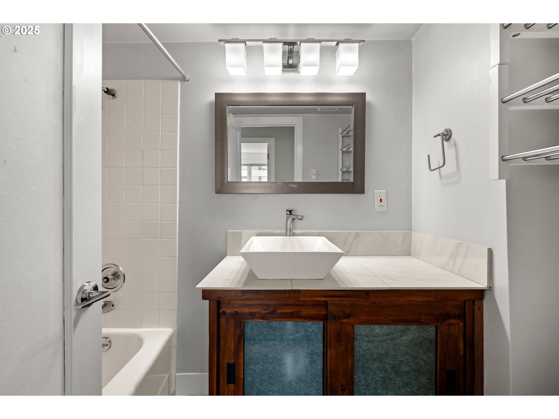 2211 Southwest Park Place, Unit 603 Portland, OR 97205 - Photo 24 of 27 a bathroom with a sink vanity granite and a mirror