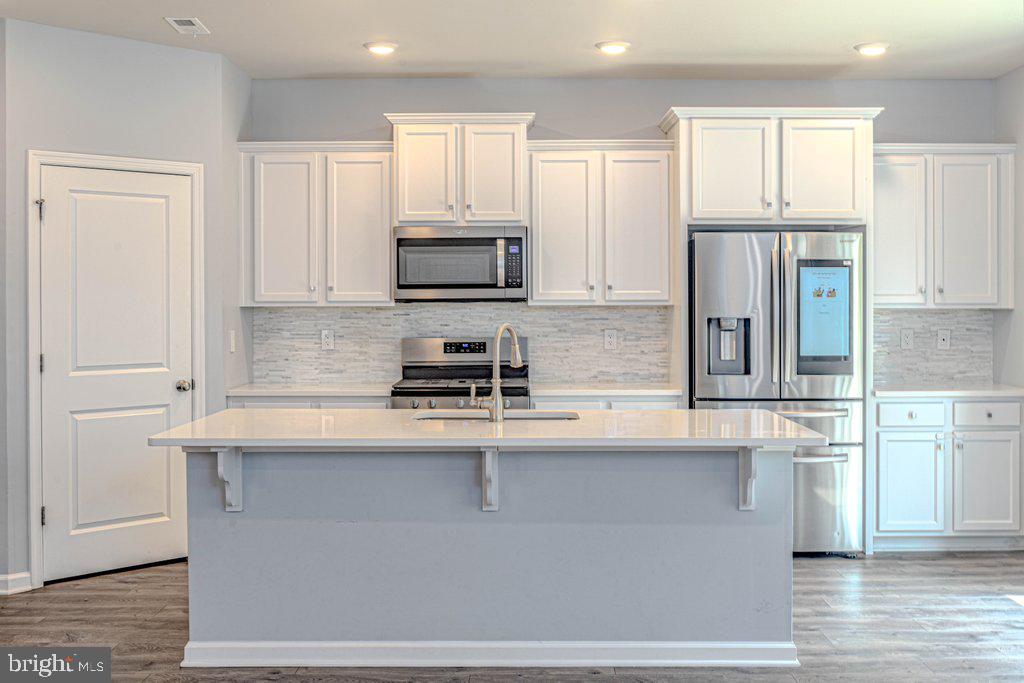 70 Morley Boulevard Medford, NJ 08055 - Photo 12 of 32 a kitchen with stainless steel appliances granite countertop a stove a sink and a refrigerator