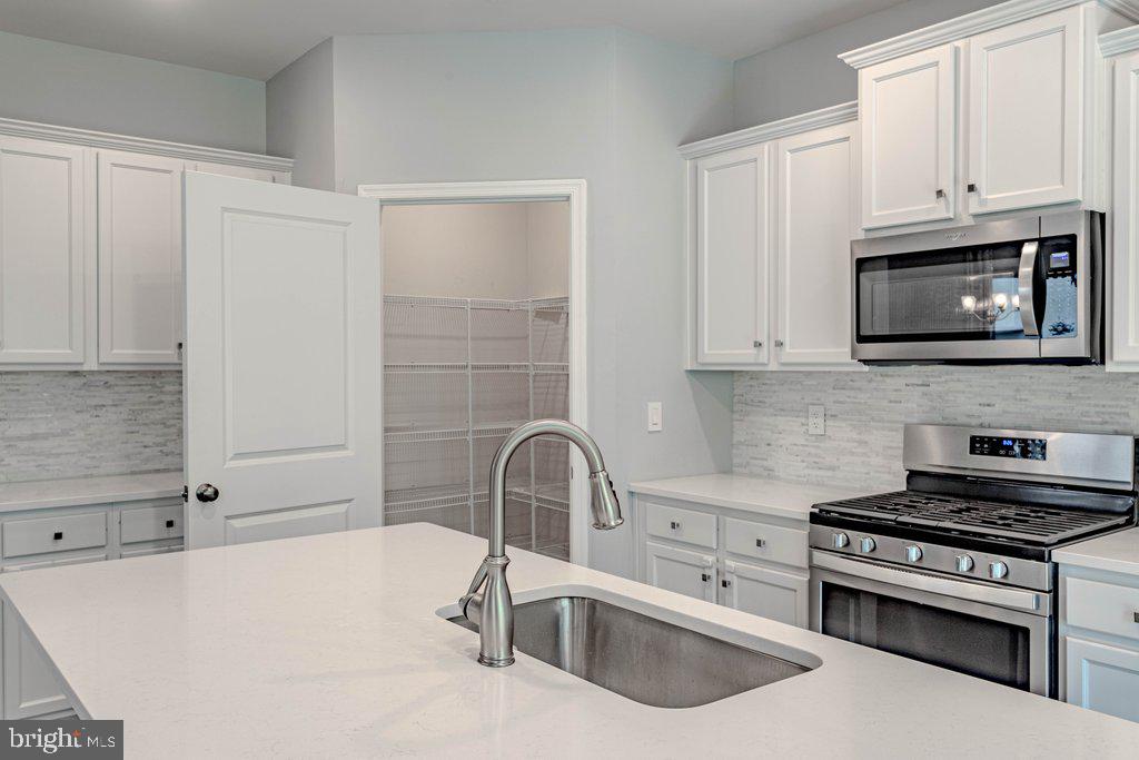 70 Morley Boulevard Medford, NJ 08055 - Photo 13 of 32 a kitchen with stainless steel appliances a sink a stove and cabinets