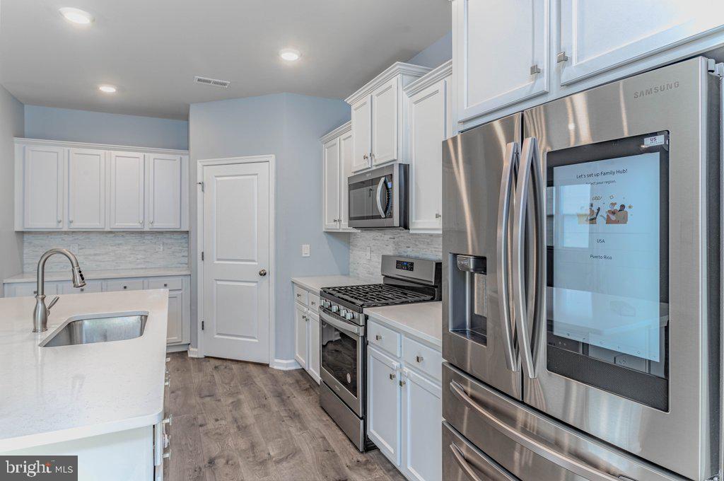 70 Morley Boulevard Medford, NJ 08055 - Photo 9 of 32 a kitchen with a refrigerator sink and stainless steel appliances