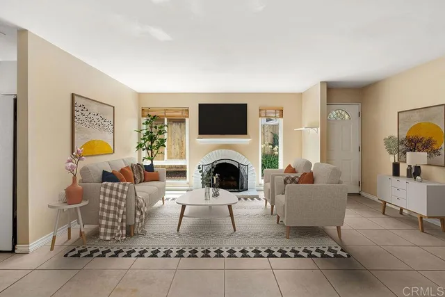 a living room with furniture a fireplace and a flat screen tv