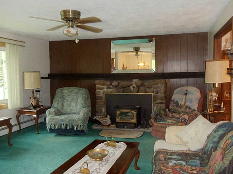 80 Guertin Street Woonsocket, RI 02895 - Photo 8 of 24 Living Room. Large living room with wood stove insert in fireplace