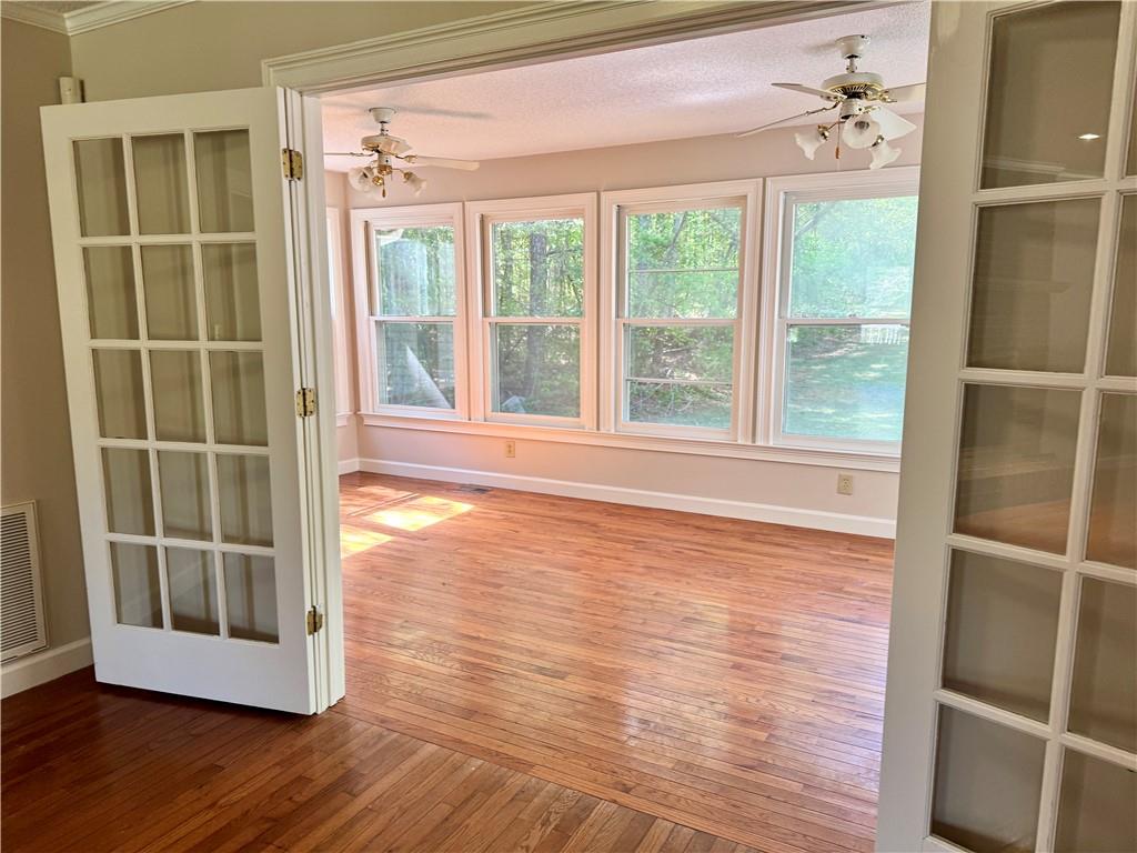 999 Grassdale Road Northwest Cartersville, GA 30121 - Photo 11 of 54 a view of an empty room with a window and wooden floor