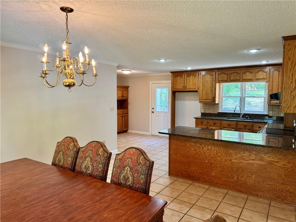 999 Grassdale Road Northwest Cartersville, GA 30121 - Photo 17 of 54 a spacious bedroom with a bed a chandelier and living room view
