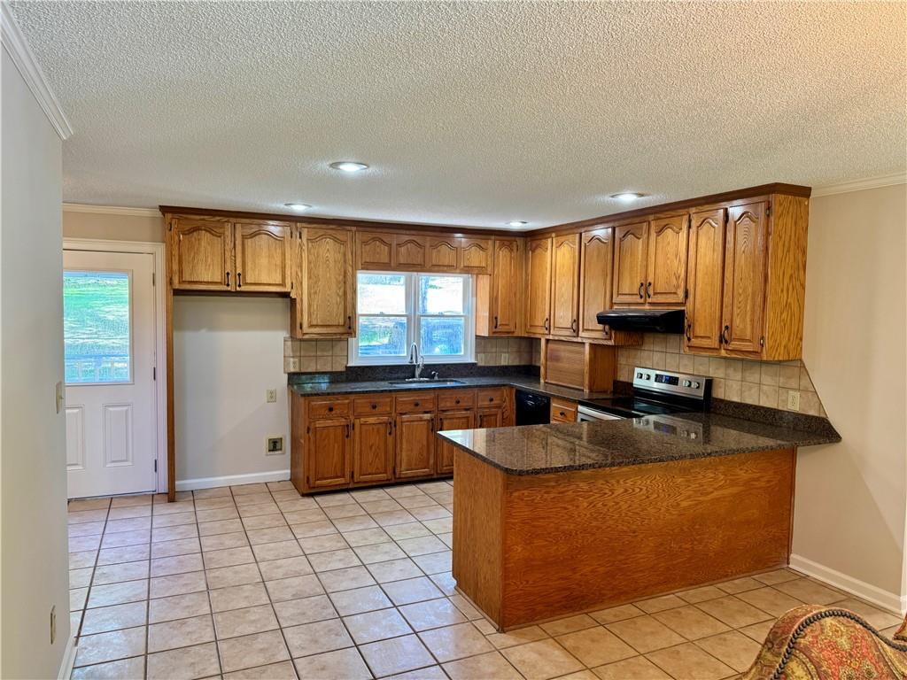 999 Grassdale Road Northwest Cartersville, GA 30121 - Photo 19 of 54 a kitchen with stainless steel appliances granite countertop a stove a sink and a microwave