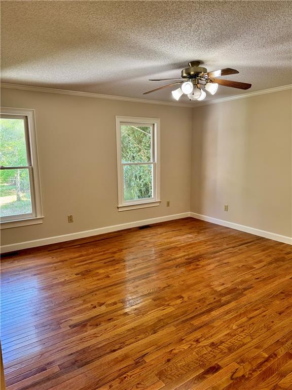 999 Grassdale Road Northwest Cartersville, GA 30121 - Photo 21 of 54 a view of an empty room with wooden floor and a window