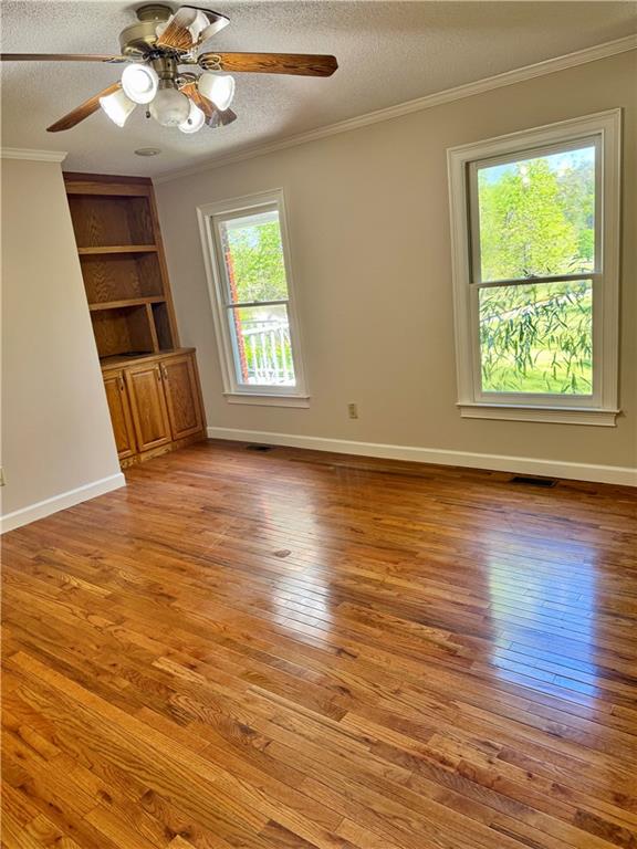 999 Grassdale Road Northwest Cartersville, GA 30121 - Photo 22 of 54 a view of an empty room with wooden floor and fan