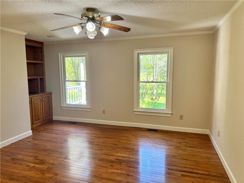 999 Grassdale Road Northwest Cartersville, GA 30121 - Photo 23 of 54 a view of an empty room with wooden floor and a window