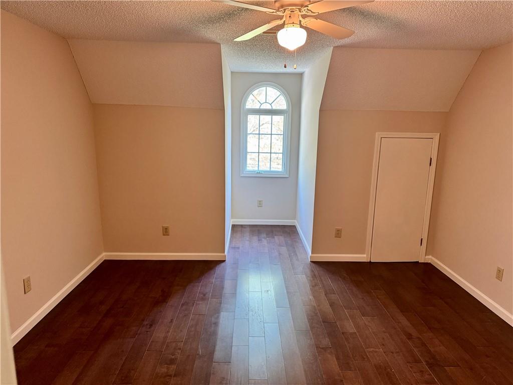 999 Grassdale Road Northwest Cartersville, GA 30121 - Photo 33 of 54 an empty room with wooden floor and windows