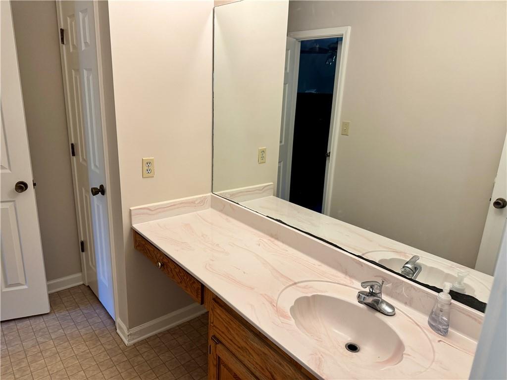 999 Grassdale Road Northwest Cartersville, GA 30121 - Photo 36 of 54 a bathroom with a sink and a mirror