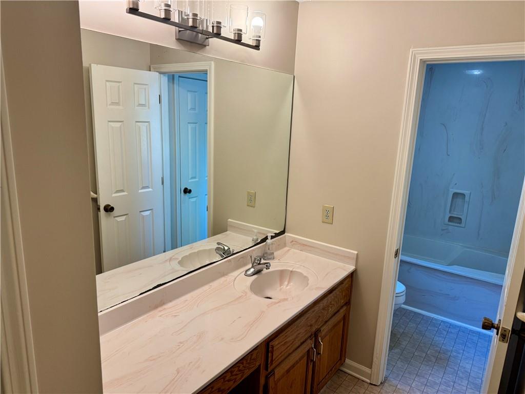 999 Grassdale Road Northwest Cartersville, GA 30121 - Photo 37 of 54 a bathroom with a sink vanity granite and a mirror