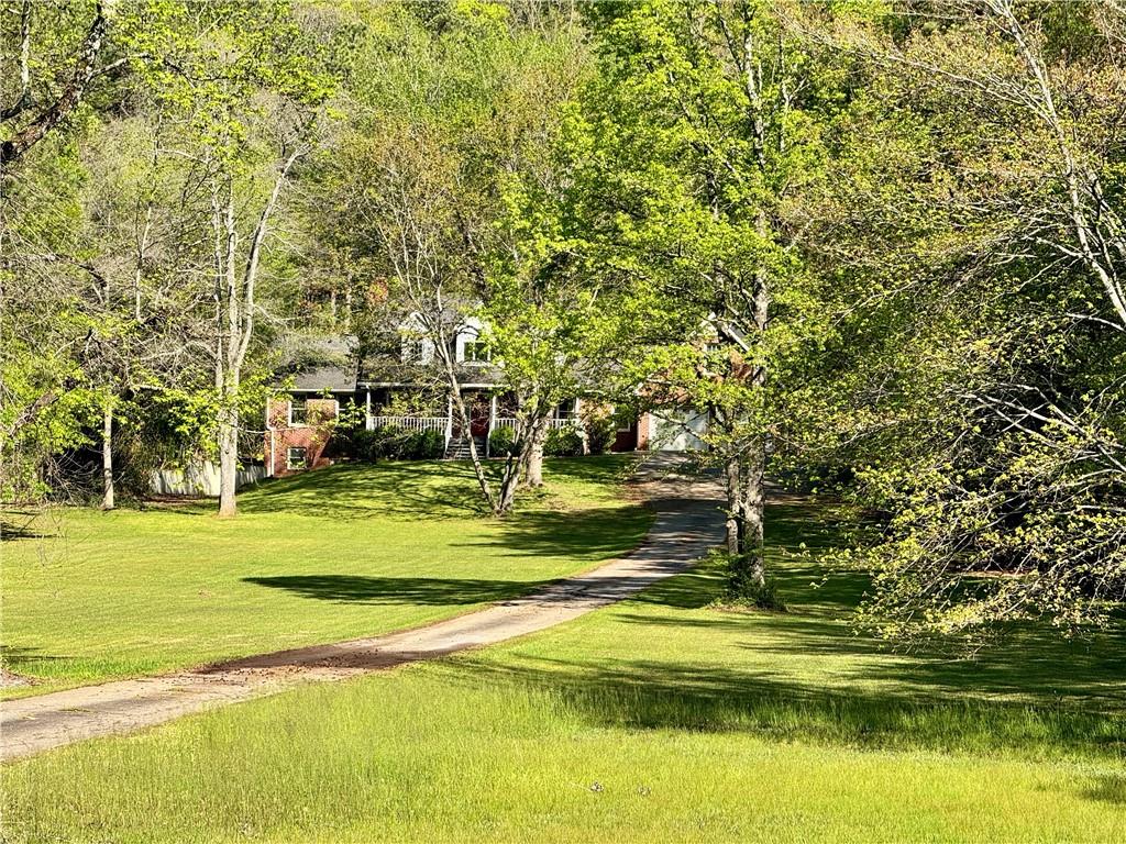 999 Grassdale Road Northwest Cartersville, GA 30121 - Photo 5 of 54 a view of a swimming pool with an outdoor space and seating area
