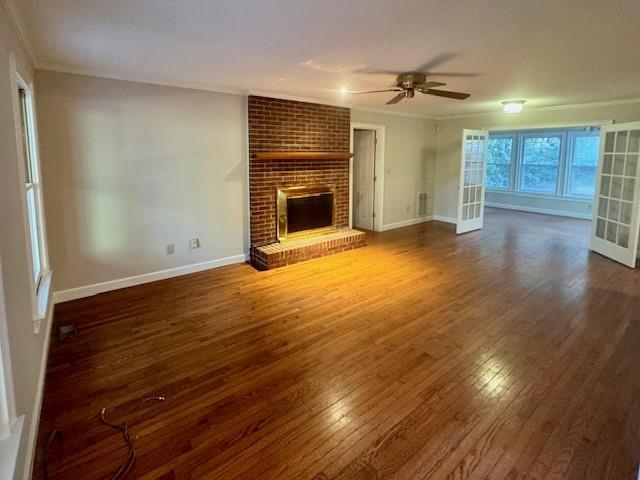 999 Grassdale Road Northwest Cartersville, GA 30121 - Photo 8 of 54 an empty room with wooden floor a fireplace and windows