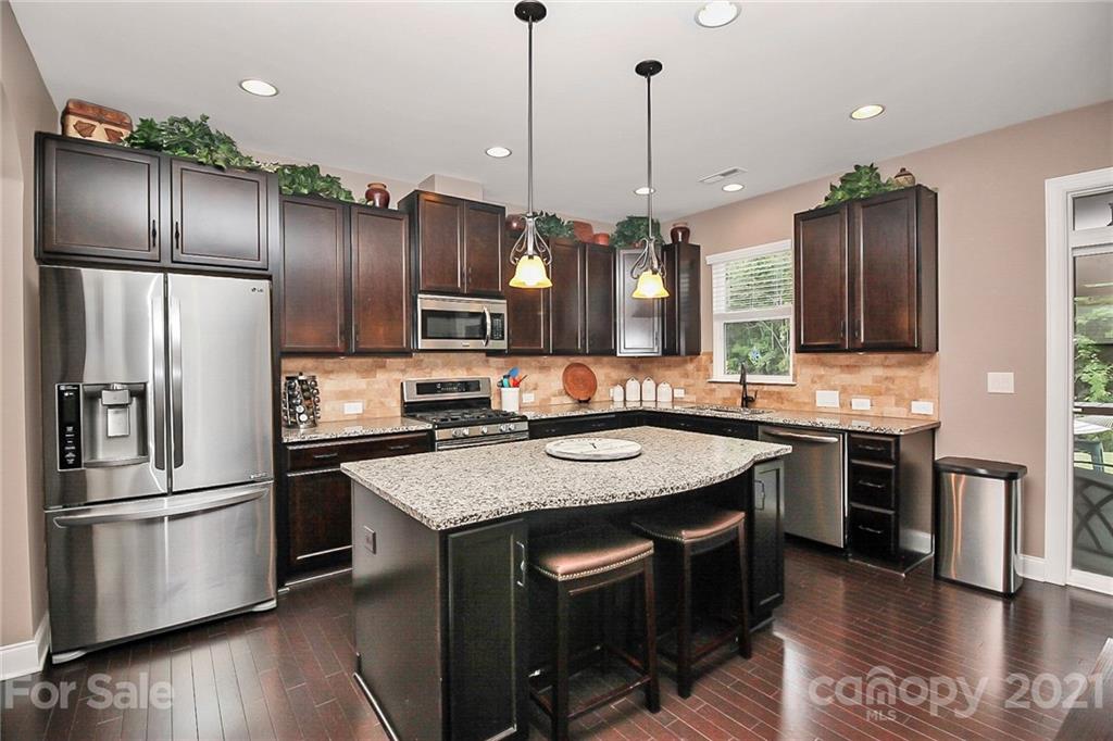 6012 Fallondale Road Waxhaw, NC 28173 - Photo 8 of 45 a kitchen with stainless steel appliances granite countertop a sink a stove and a refrigerator
