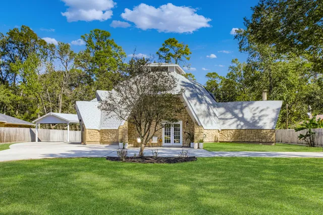 a view of swimming pool with table and chairs and a large tree