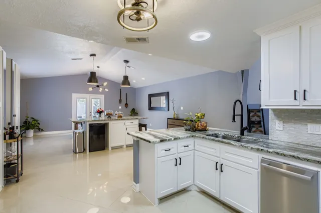 a kitchen with a sink cabinets and window