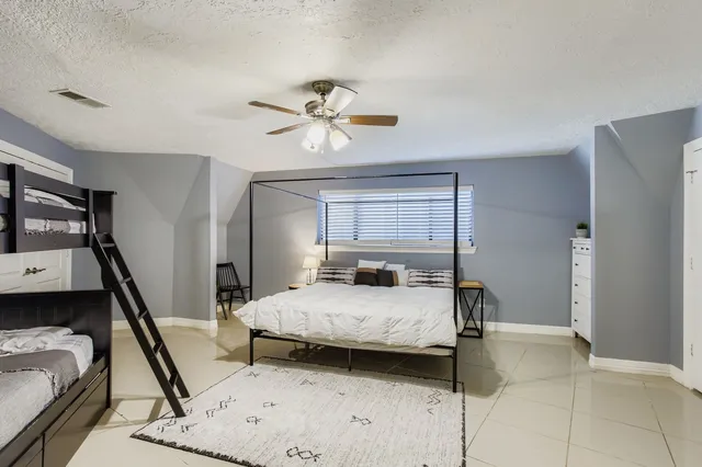 a en suite bathroom with a granite countertop tub and a sink
