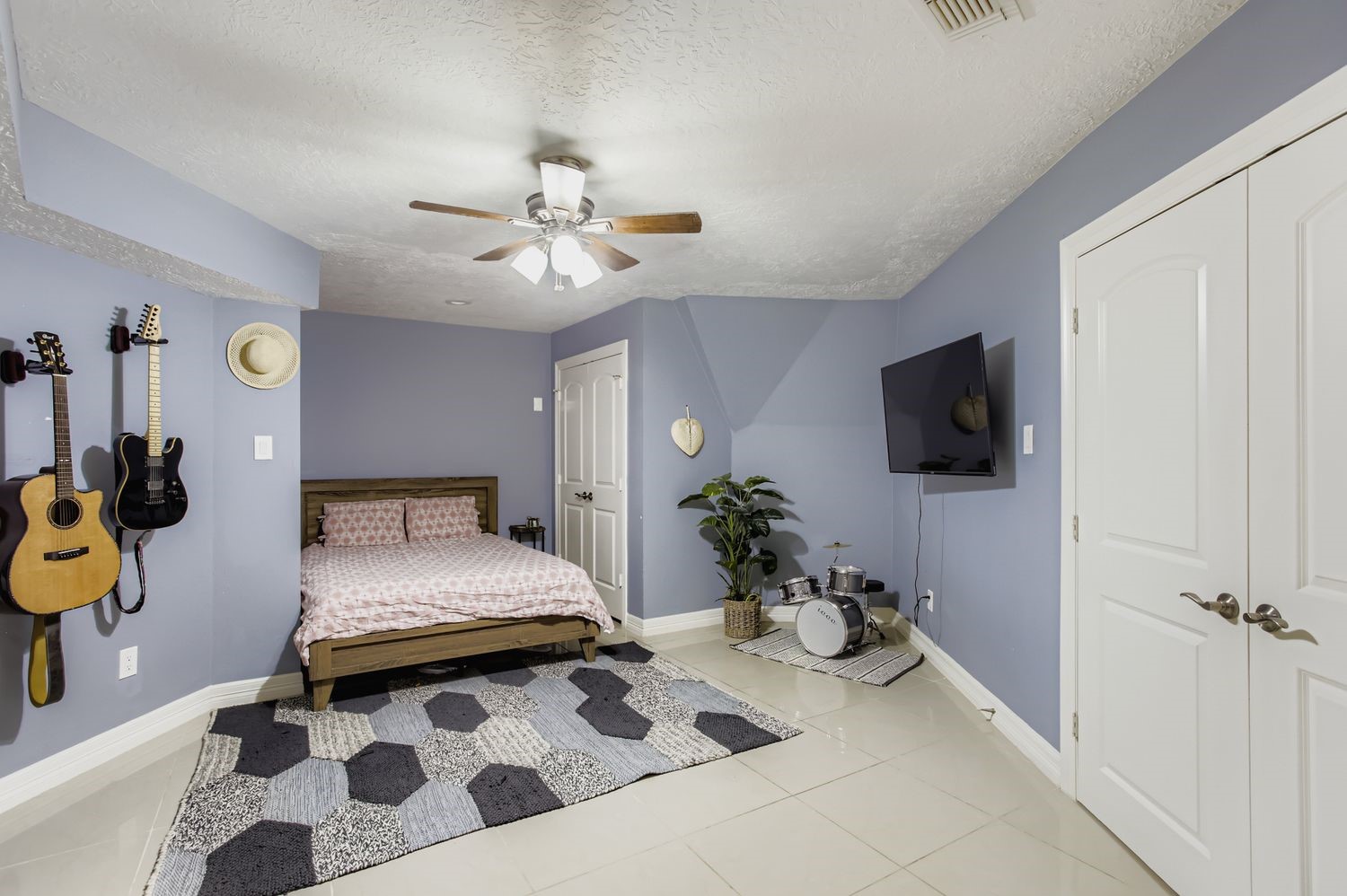16614 Creeksouth Road Houston, TX 77068 - Photo 17 of 36 a bedroom with a bed and a flat screen tv