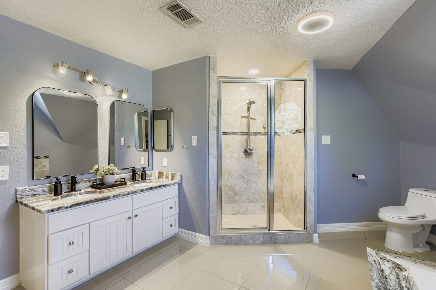 16614 Creeksouth Road Houston, TX 77068 - Photo 19 of 36 a spacious bathroom with a double vanity sink toilet and shower