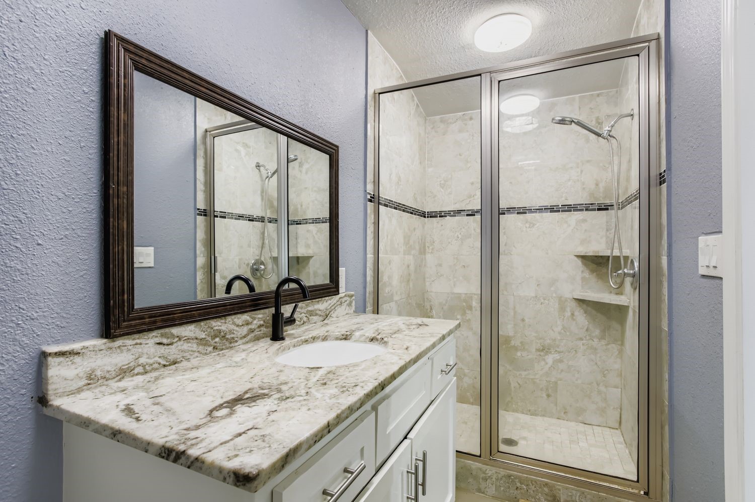 16614 Creeksouth Road Houston, TX 77068 - Photo 28 of 36 a bathroom with a granite countertop sink mirror and vanity