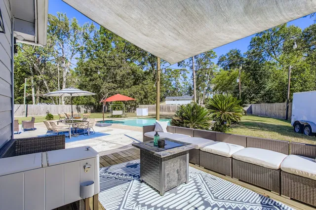 a patio with a table and chairs under an umbrella