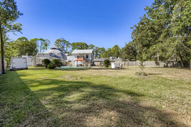 a view of backyard with outdoor seating and green space