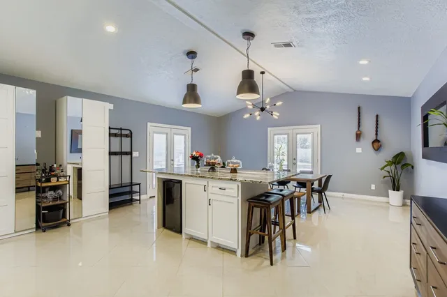 a view of a dining room with furniture and chandelier