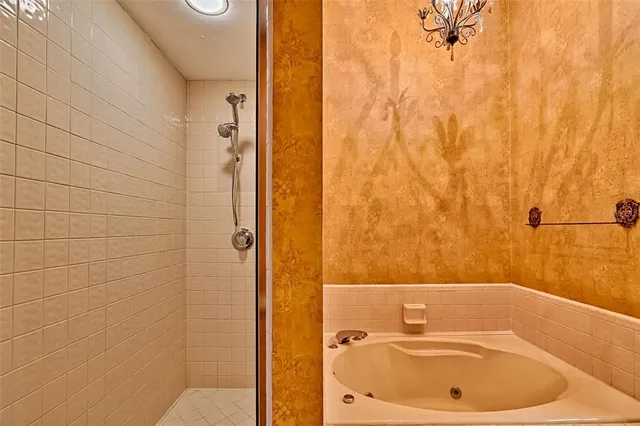 an empty room with wooden floor and a ceiling fan