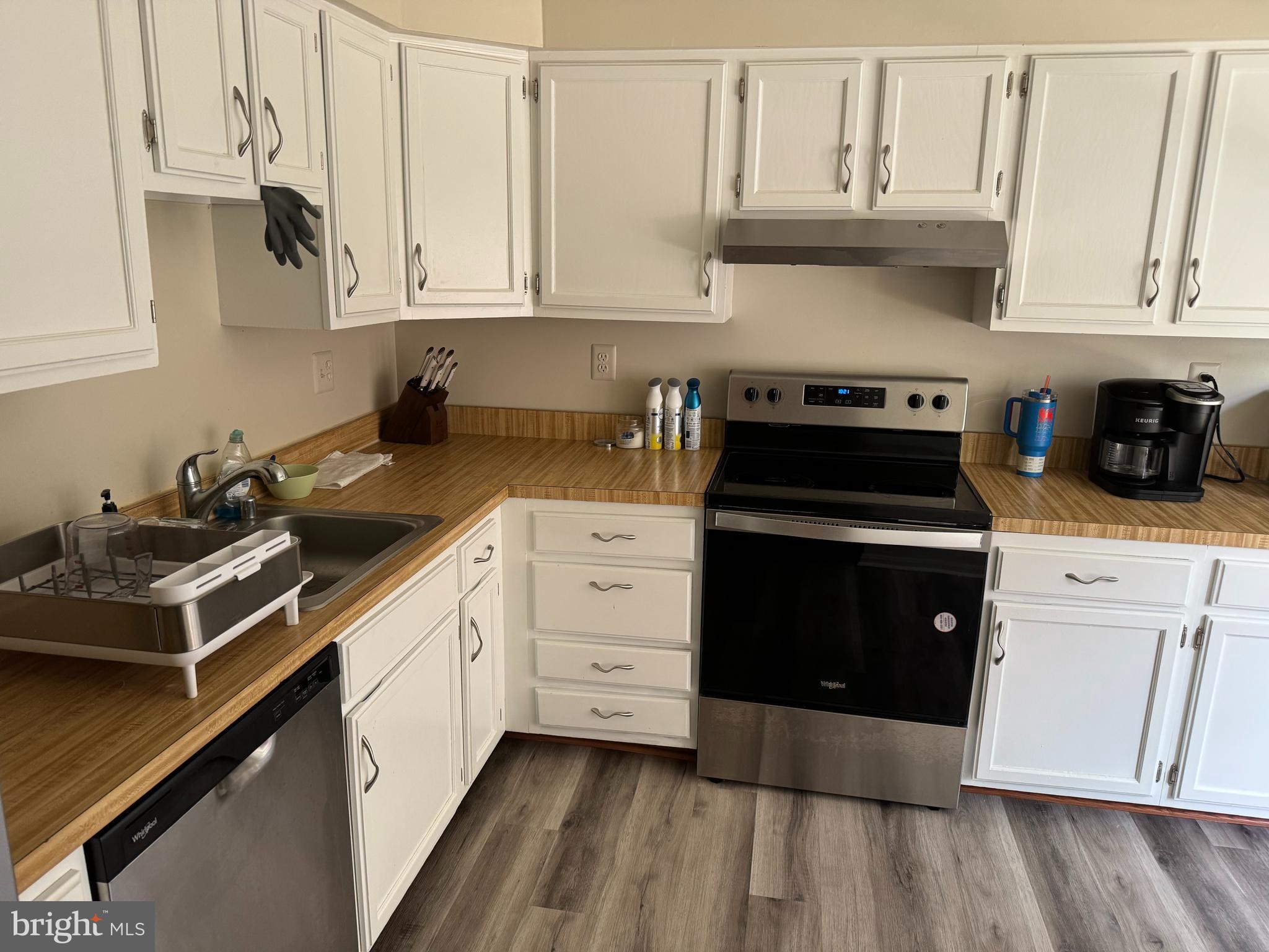 10946 Rampart Way Silver Spring, MD 20902 - Photo 2 of 11 a kitchen with white cabinets and appliances