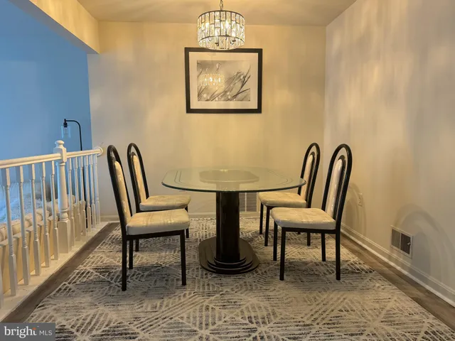 a view of a hallway with wooden floor and furniture