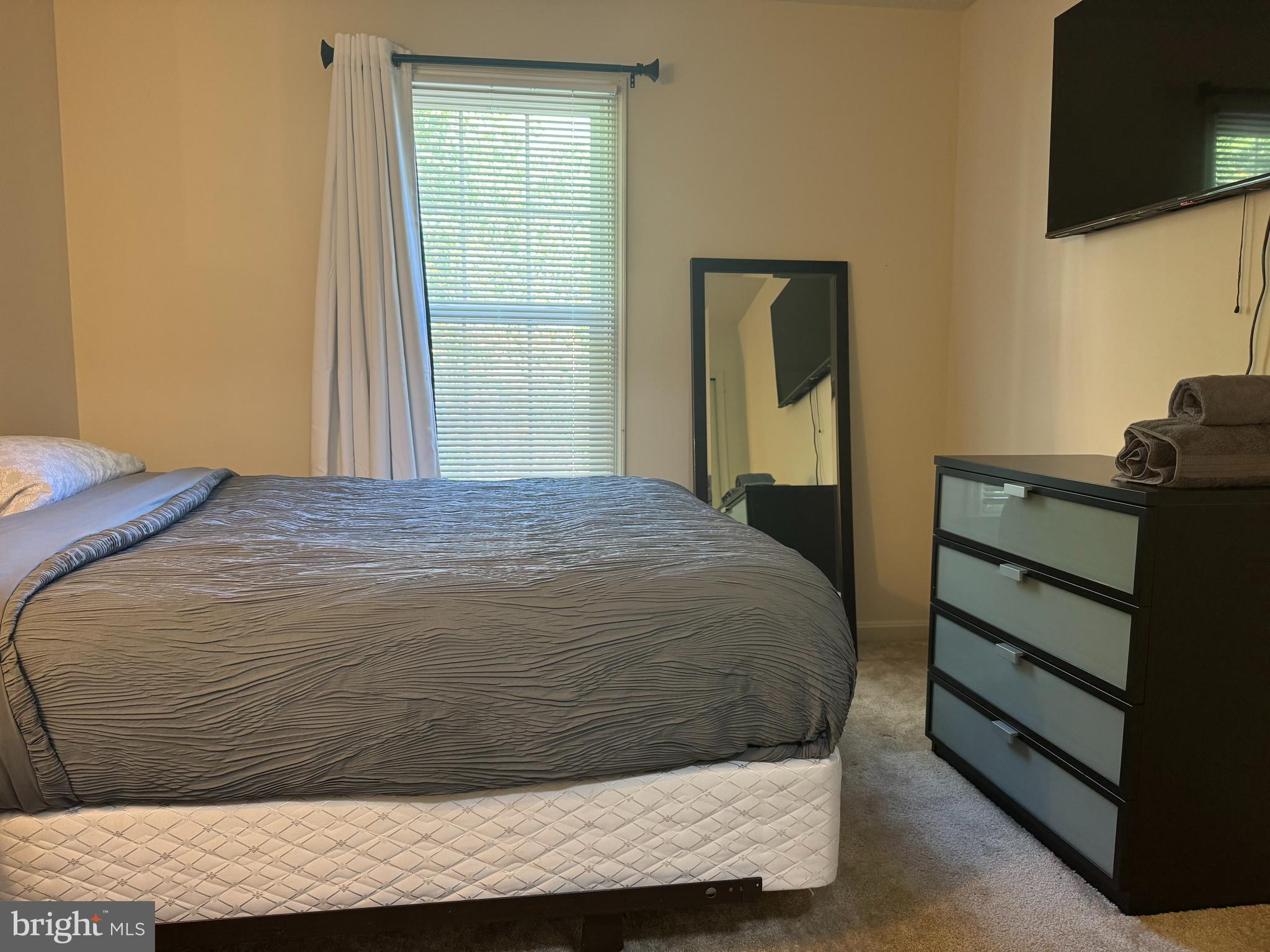 10946 Rampart Way Silver Spring, MD 20902 - Photo 7 of 11 a bedroom with a bed and a flat screen tv