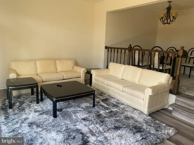 a living room with furniture and a rug