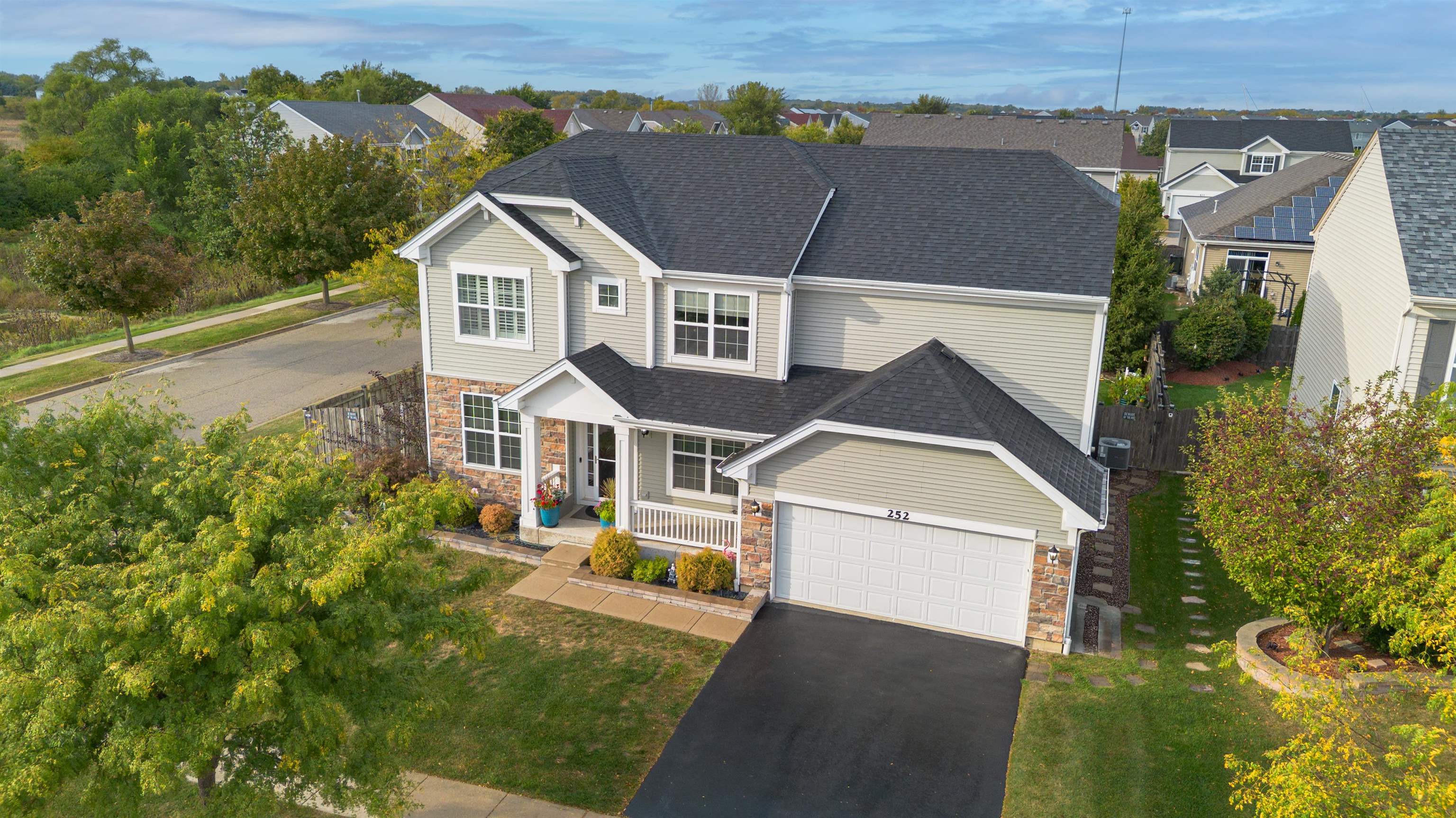 an aerial view of a house with a yard