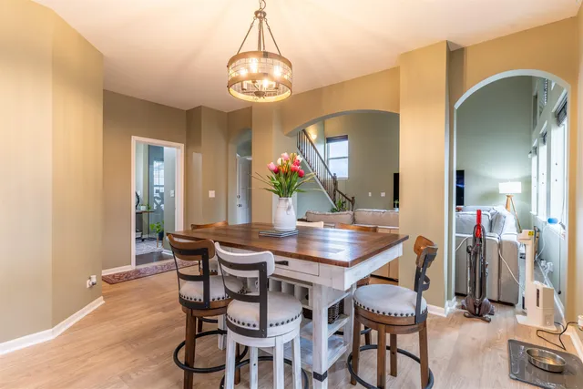 a view of a dining room with furniture and chandelier