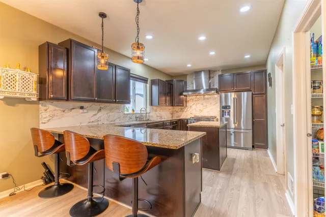 a kitchen with stainless steel appliances granite countertop counter space a sink and cabinets