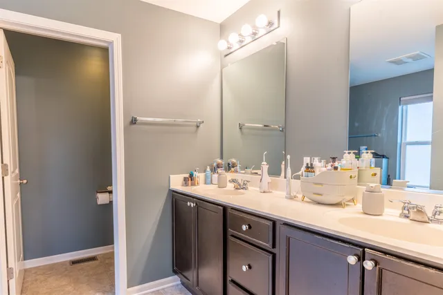 a bathroom with a sink double vanity and a mirror