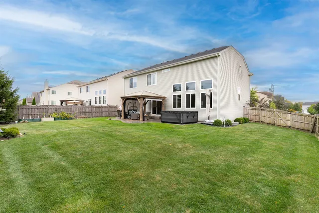 a view of house with backyard