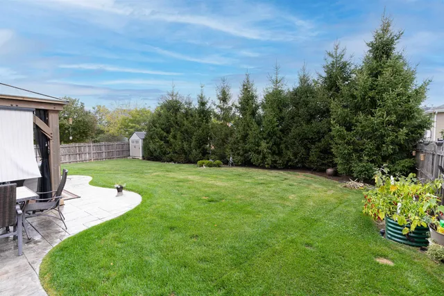 a view of a backyard with sitting area
