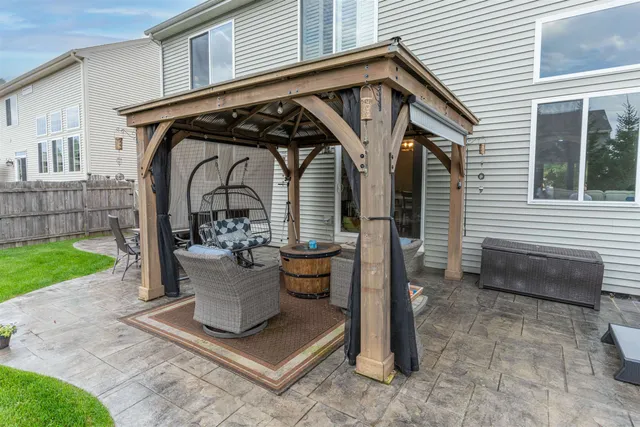 a view of a house with backyard and sitting area