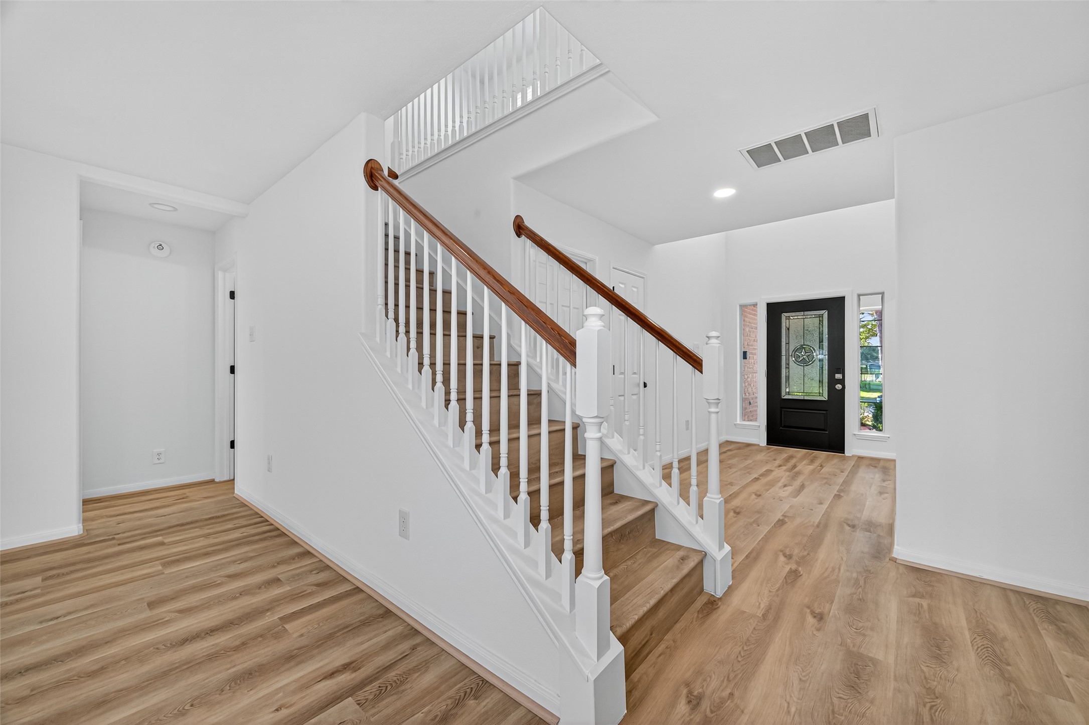 17422 Bending Post Drive Houston, TX 77095 - Photo 13 of 50 a view of a hallway with wooden floor and staircase