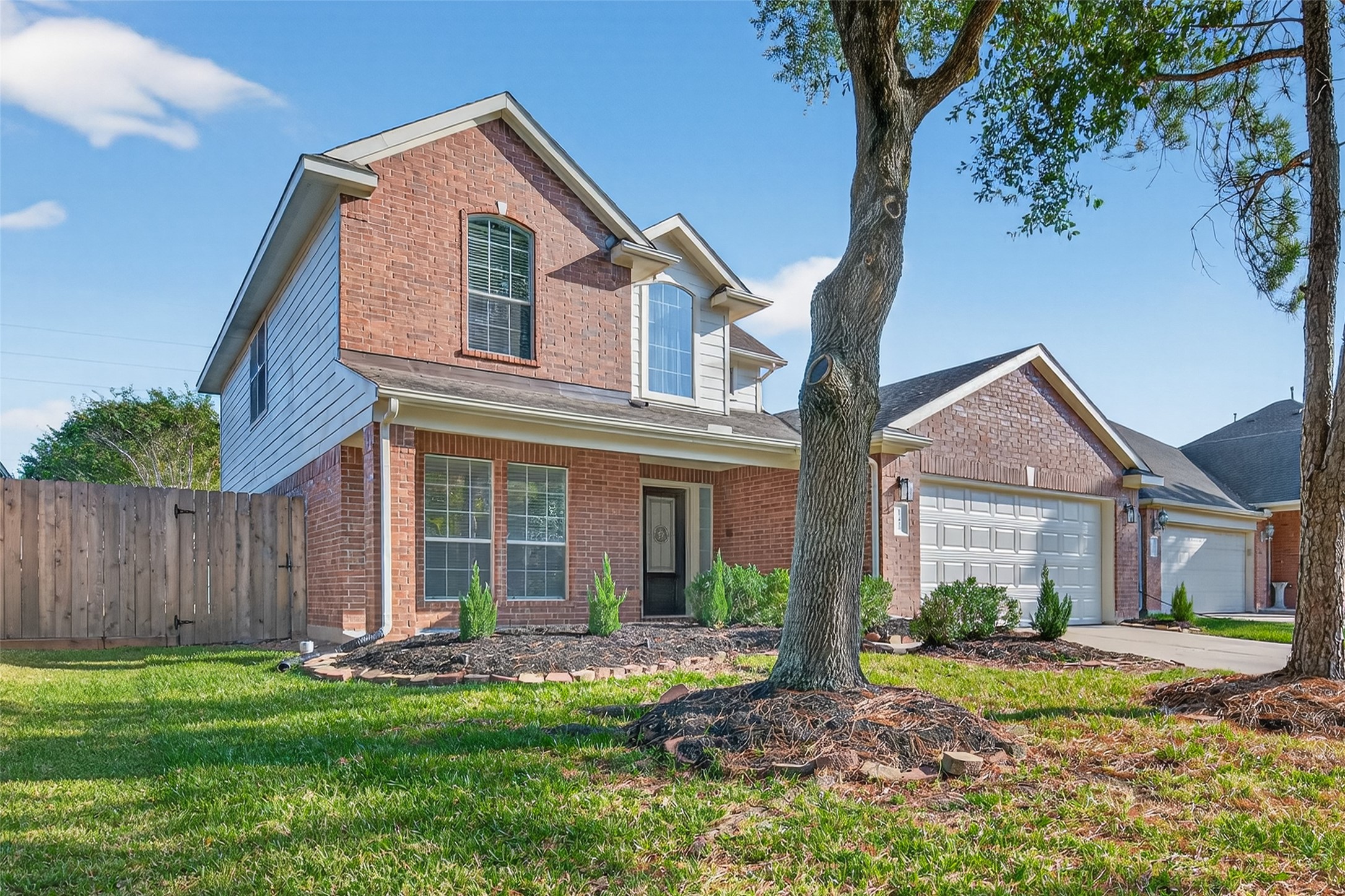 17422 Bending Post Drive Houston, TX 77095 - Photo 2 of 50 a front view of a house with a yard and garage