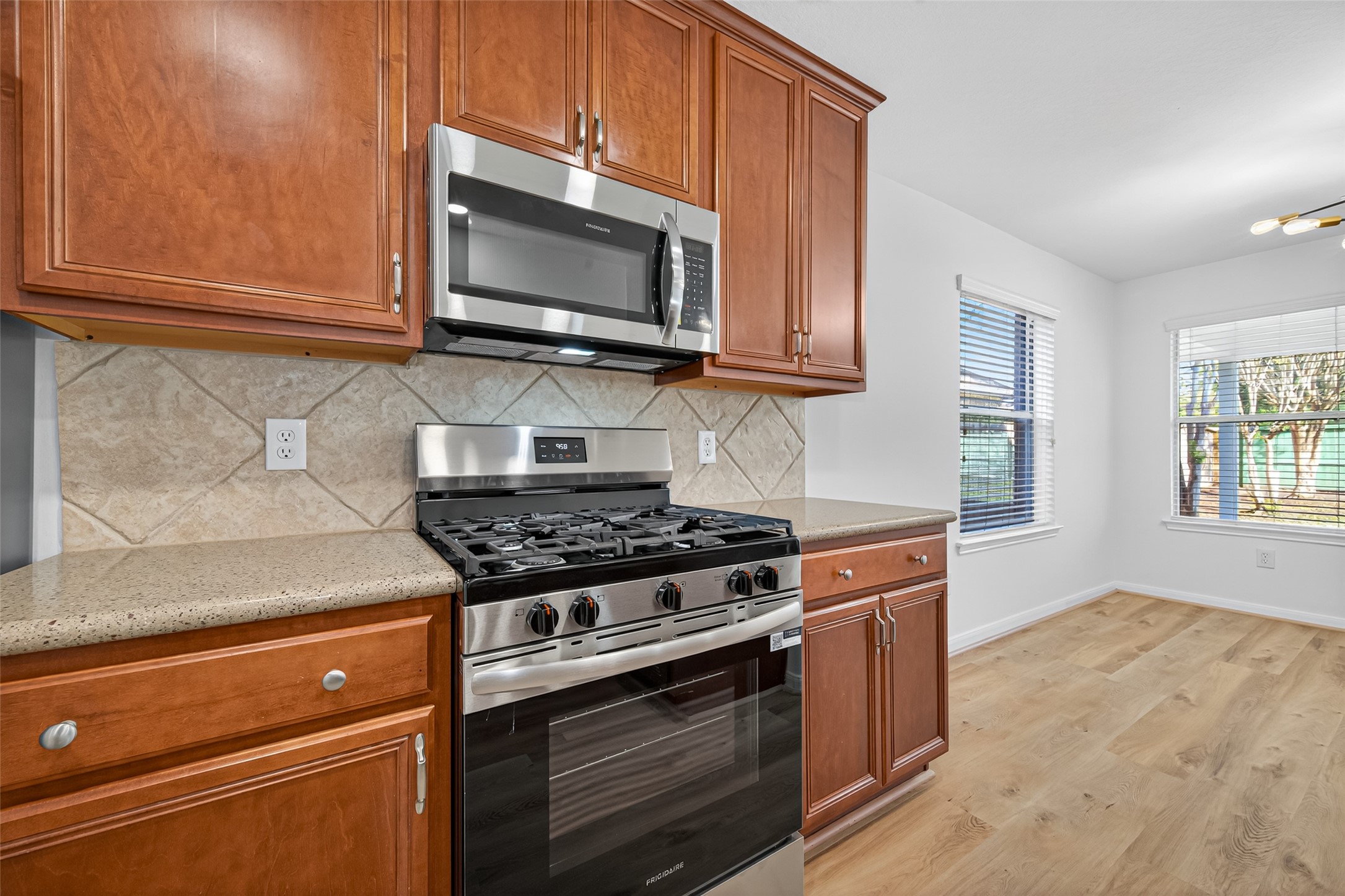 17422 Bending Post Drive Houston, TX 77095 - Photo 23 of 50 a kitchen with stainless steel appliances granite countertop a stove microwave and sink