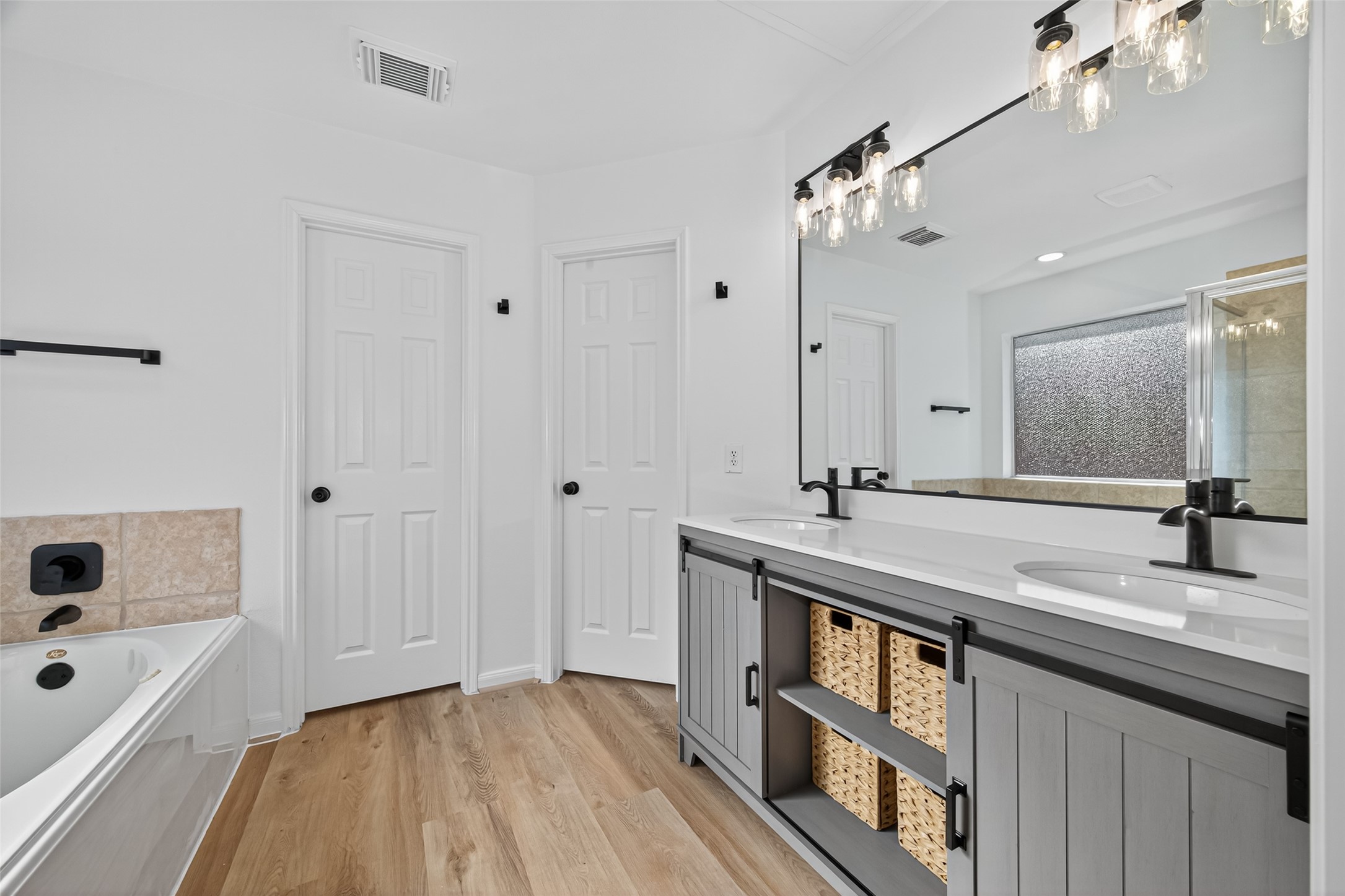 17422 Bending Post Drive Houston, TX 77095 - Photo 32 of 50 a bathroom with a sink a vanity a mirror and shower