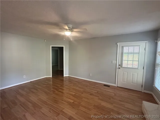 wooden floor in an empty room with a window
